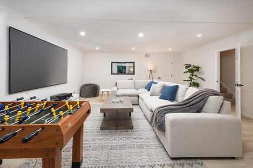 A living room with a couch, table and television.