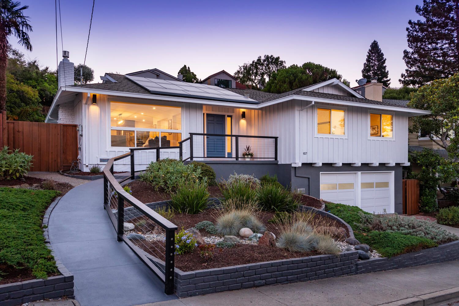 A house with a garden in the front yard.