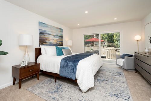 A bedroom with a large bed and a window.